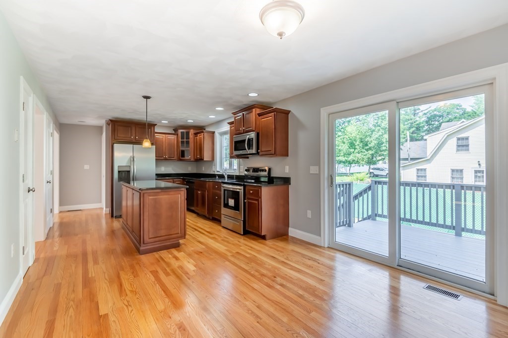12 Bell Road Tewksbury, MA 01876 - Photo 9 of 26 a kitchen with stainless steel appliances granite countertop a refrigerator stove top oven and sink