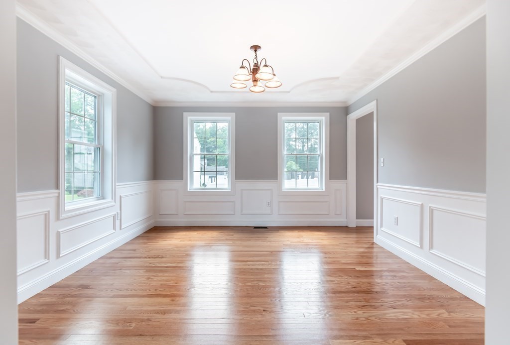 12 Bell Road Tewksbury, MA 01876 - Photo 10 of 26 a view of an empty room with wooden floor and a window