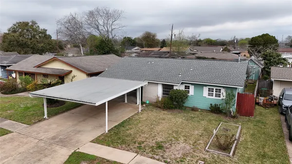 an aerial view of residential houses with outdoor space
