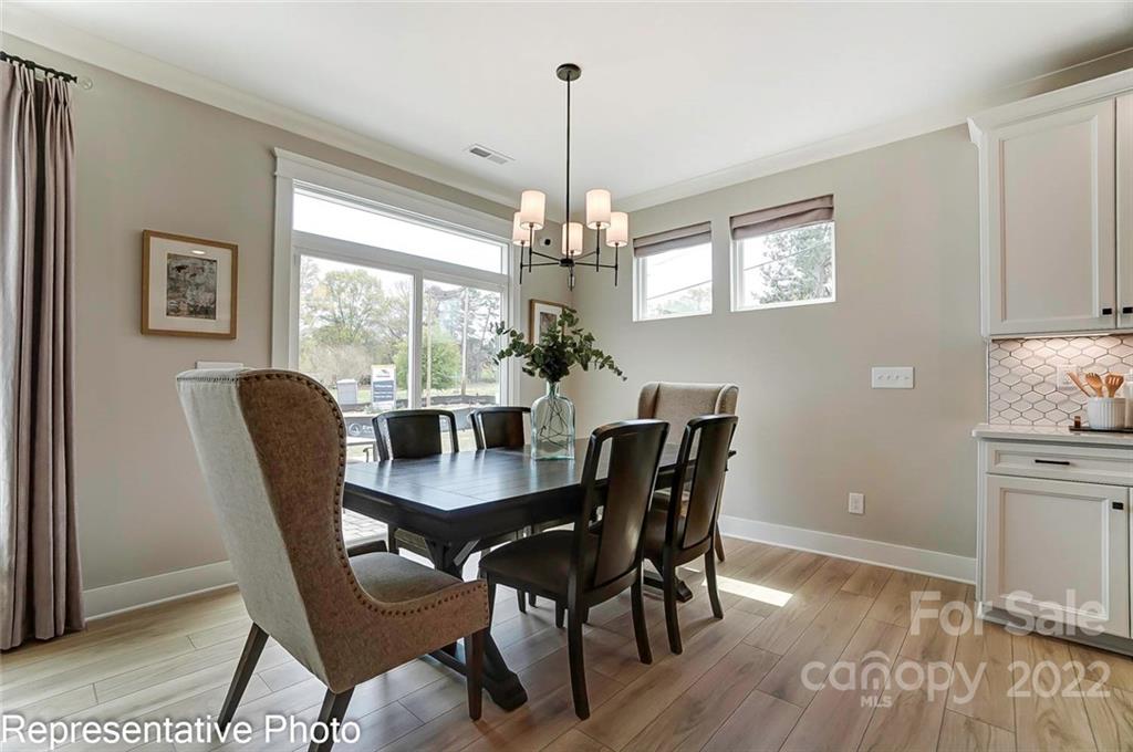 2345 Windley Drive Gastonia, NC 28054 - Photo 18 of 32 a dining room with furniture a chandelier and wooden floor