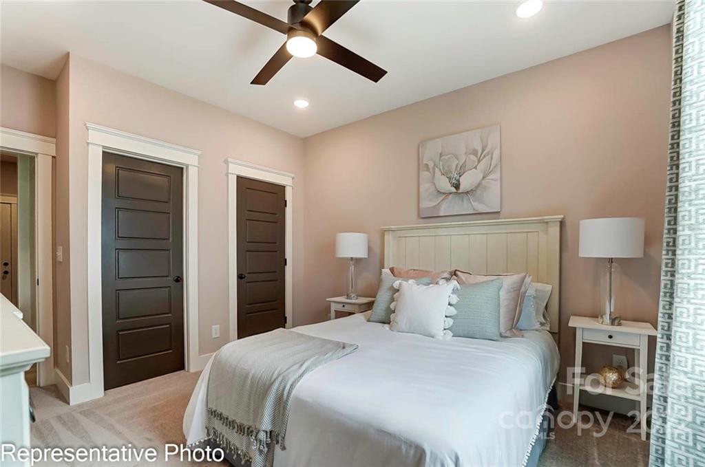 2345 Windley Drive Gastonia, NC 28054 - Photo 19 of 32 a bedroom with a bed and a lamp on table