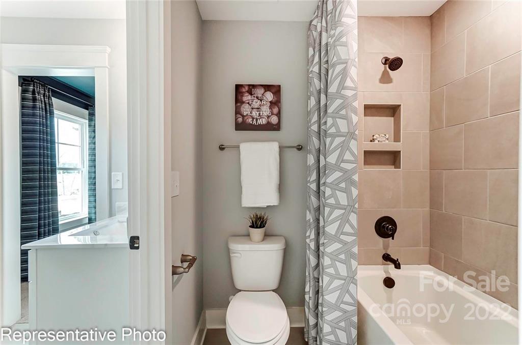 2345 Windley Drive Gastonia, NC 28054 - Photo 31 of 32 a bathroom with a toilet sink and shower