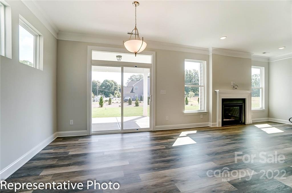 2345 Windley Drive Gastonia, NC 28054 - Photo 9 of 32 a view of an empty room with wooden floor and a window
