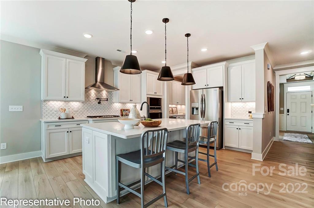 2345 Windley Drive Gastonia, NC 28054 - Photo 10 of 32 a kitchen with stainless steel appliances kitchen island a refrigerator and a wooden floor