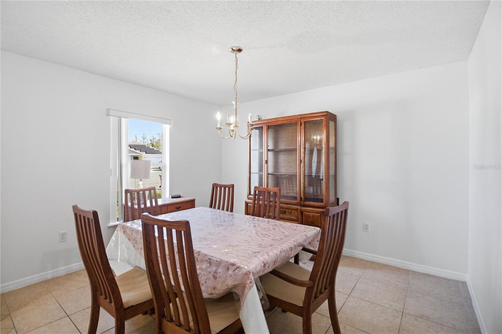 206 Taranto Way Kissimmee, FL 34758 - Photo 6 of 45 a view of a dining room with furniture window and wooden floor