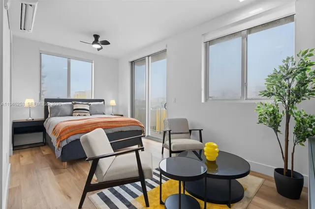 a bedroom with a bed and chandelier