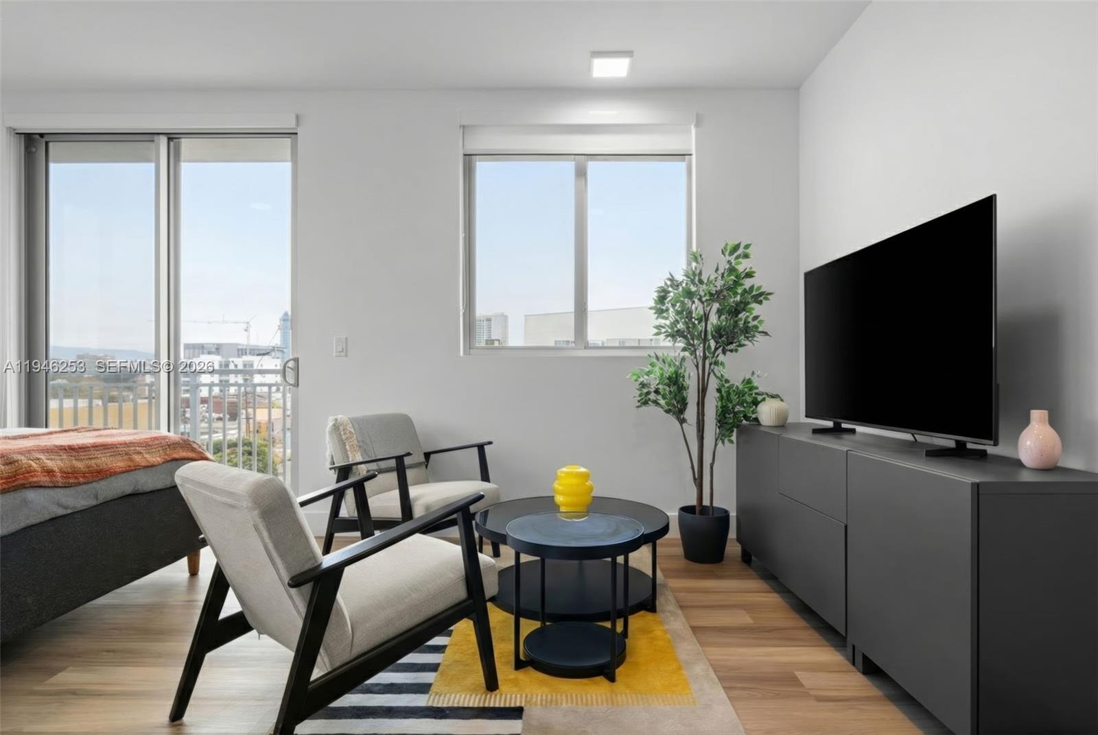 650 Southwest 1st Street, Unit 305 Miami, FL 33130 - Photo 12 of 28 a living room with furniture and a flat screen tv