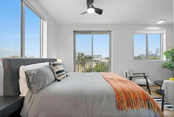 a bedroom with a bed and windows