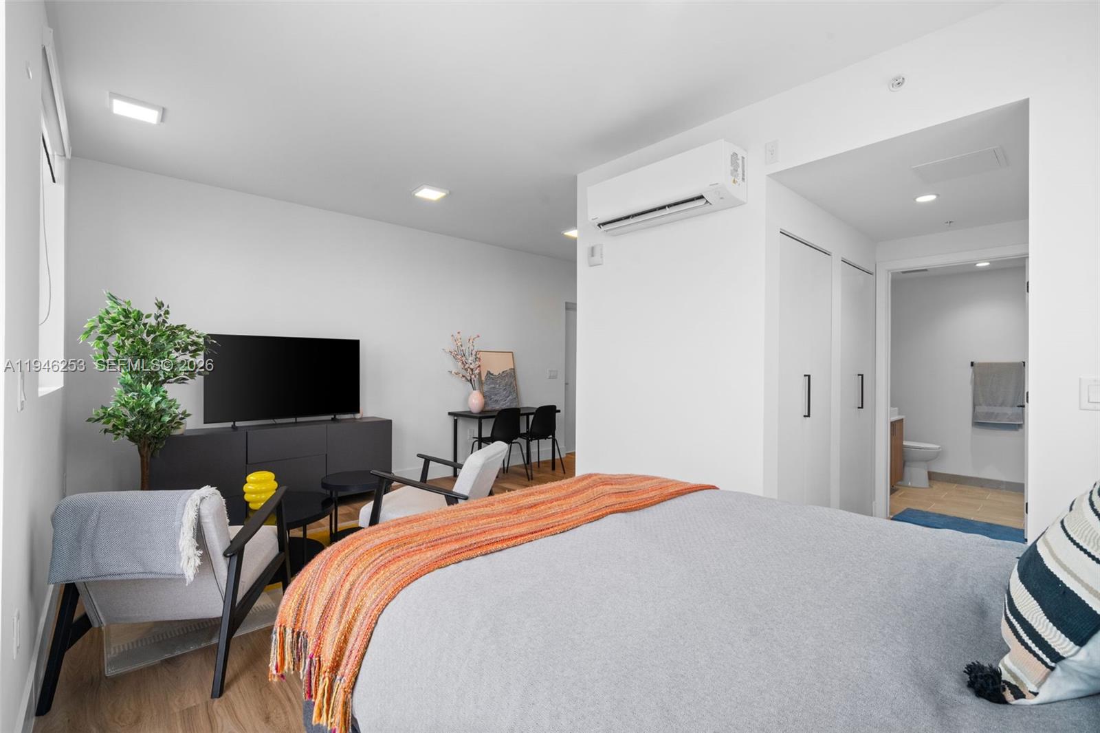 650 Southwest 1st Street, Unit 305 Miami, FL 33130 - Photo 15 of 28 a bedroom with a bed and a television