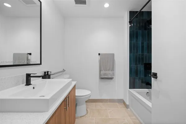 a bathroom with a sink a toilet and bathtub