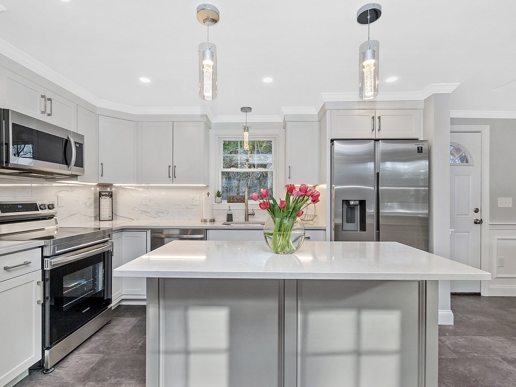 46 Shawsheen Road Billerica, MA 01821 - Photo 4 of 18 a kitchen with granite countertop a sink stainless steel appliances and white cabinets