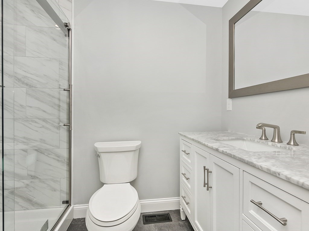 46 Shawsheen Road Billerica, MA 01821 - Photo 7 of 18 a bathroom with a granite countertop toilet sink and mirror