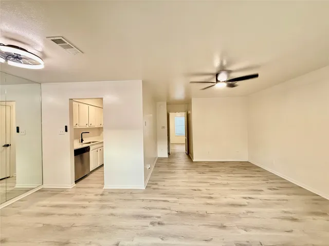 a view of a kitchen with a sink and refrigerator