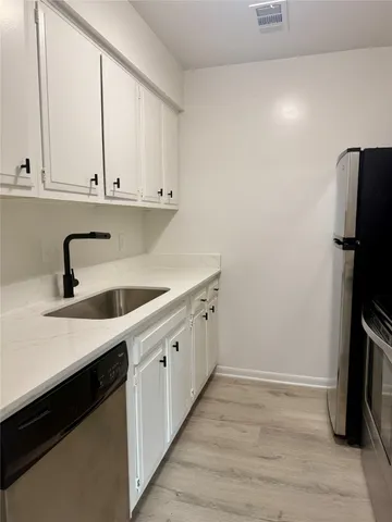 a kitchen with a sink and a refrigerator