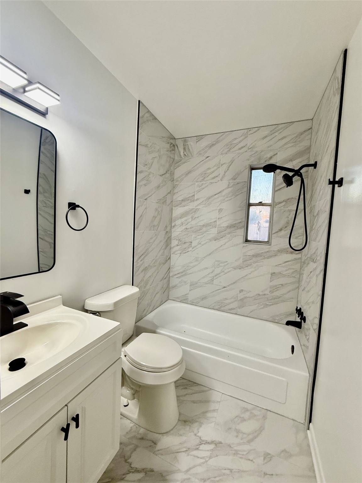 6401 Skyline Drive, Unit 36 Houston, TX 77057 - Photo 10 of 14 a bathroom with a sink a toilet and shower