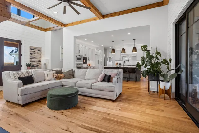 a kitchen with stainless steel appliances a sink a stove a microwave a center island and cabinets