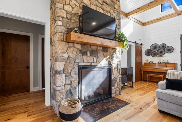 a kitchen with stainless steel appliances kitchen island granite countertop a sink a stove and a wooden floors