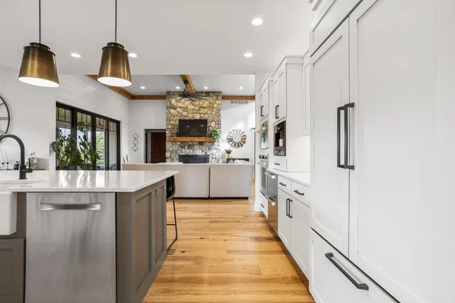 a kitchen with stainless steel appliances cabinets and a window