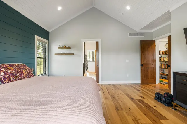 a living room with stainless steel appliances kitchen island granite countertop furniture and a wooden floor