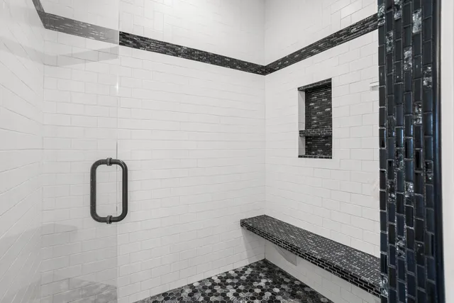 a living room with furniture a flat screen tv and kitchen view