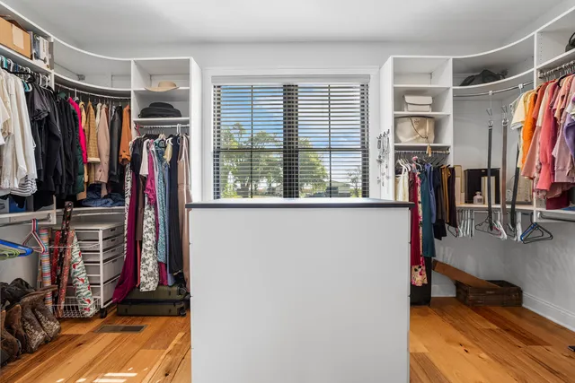 a living room with furniture and floor to ceiling window