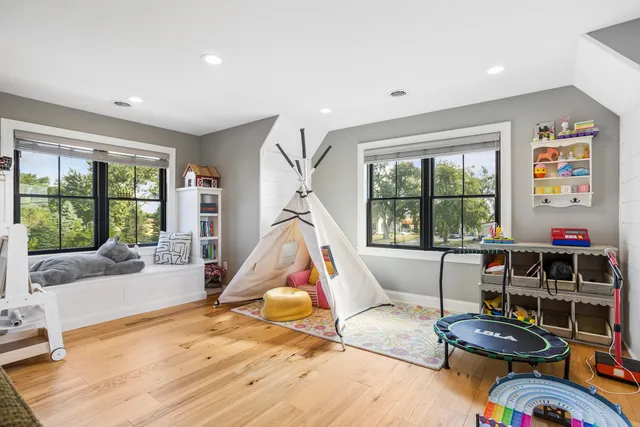 a bathroom with a toilet sink double vanity and bathtub