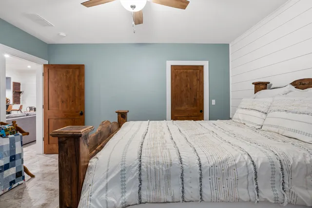 an aerial view of a house with a garden and lake view