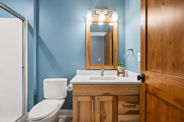 a view of a house with a big yard and large trees