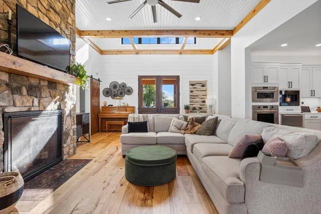 a living room filled with furniture and a wooden floor