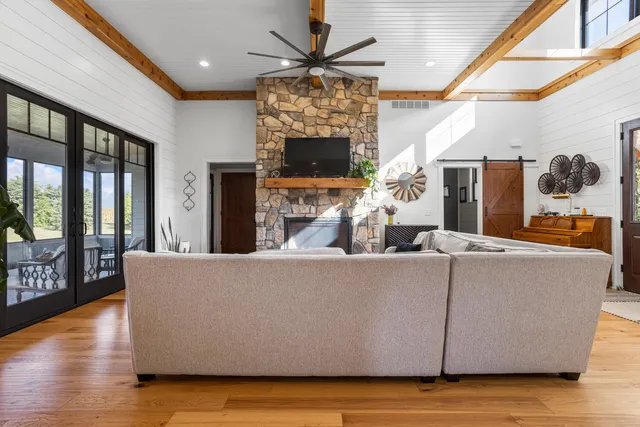 a kitchen with stainless steel appliances kitchen island granite countertop a dining table chairs and sink