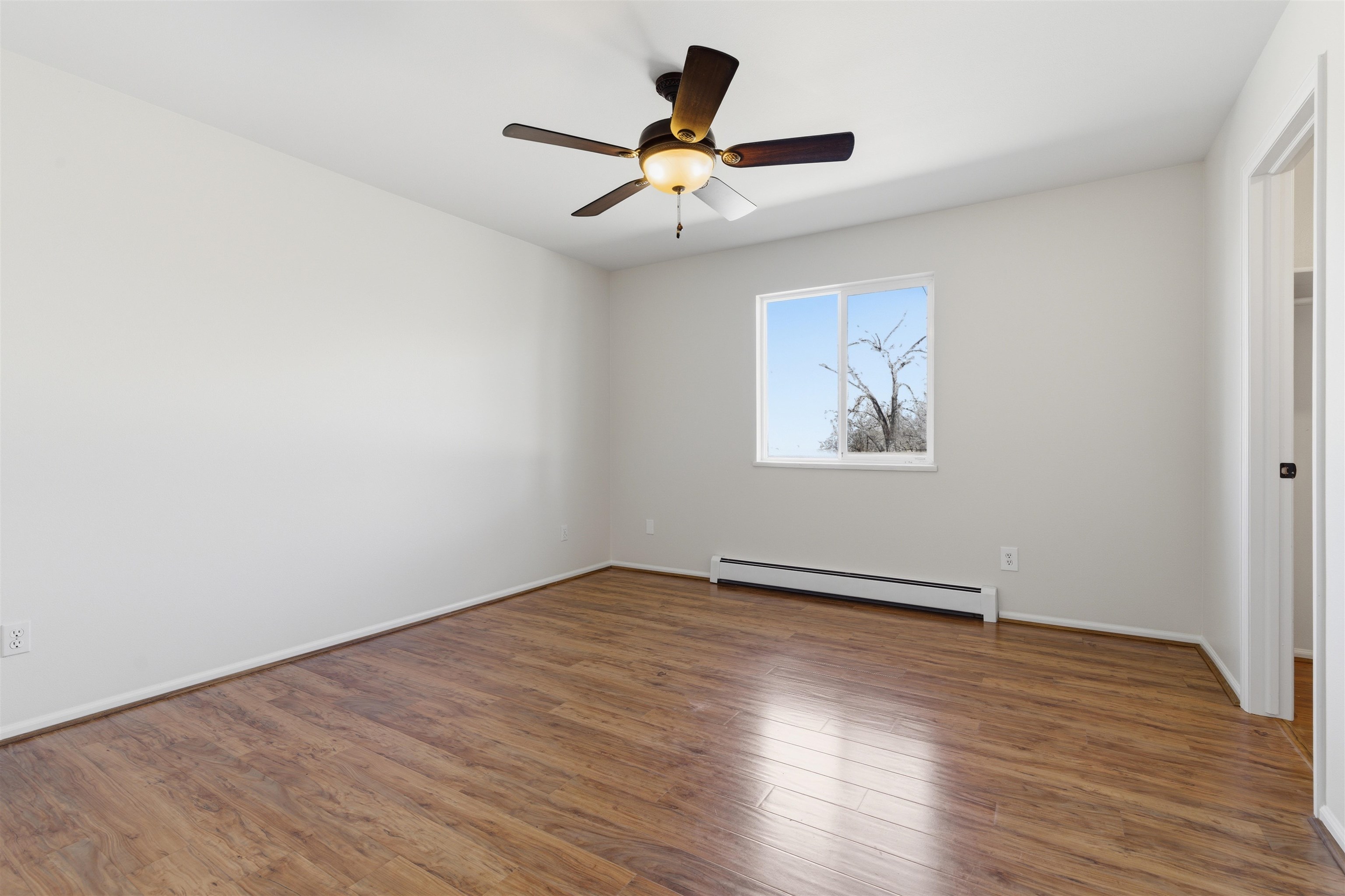 1820 Bittern Court Grand Junction, CO 81506 - Photo 15 of 28 an empty room with wooden floor chandelier fan and windows