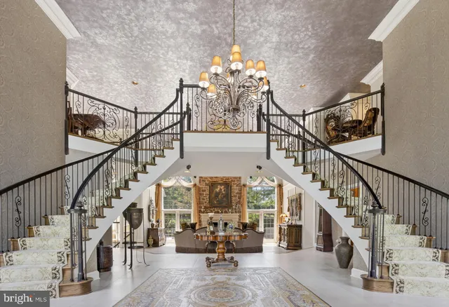 a spacious bedroom with a bed a couch and dresser next to a window