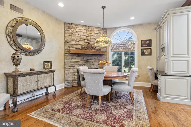 a view of a patio with table and chairs under an umbrella