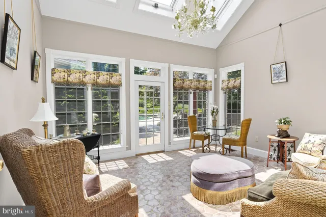a view of an empty room with a fireplace and a chandelier