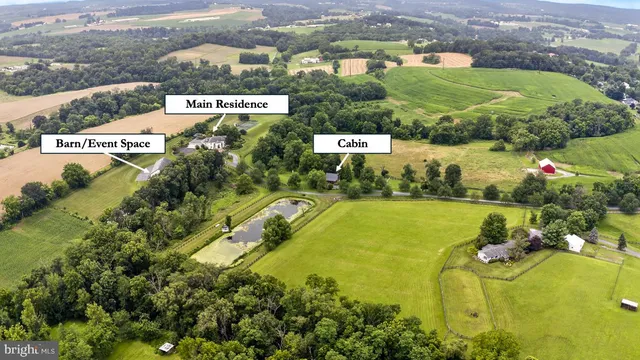 a kitchen with granite countertop a window a sink and white cabinets