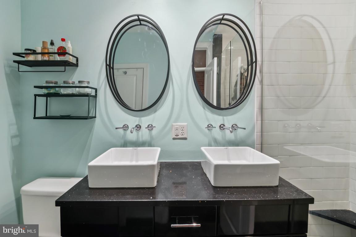 121 South Curley Street Baltimore, MD 21224 - Photo 24 of 40 Sleek dual sinks in a modern bathroom.