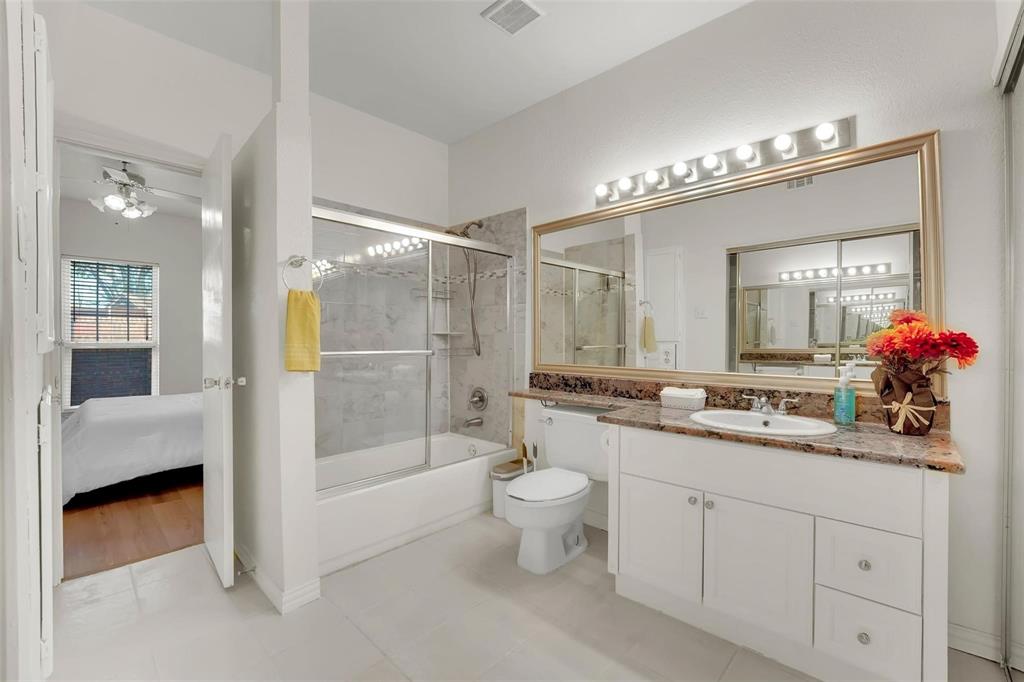 a bathroom with a double vanity sink mirror and toilet
