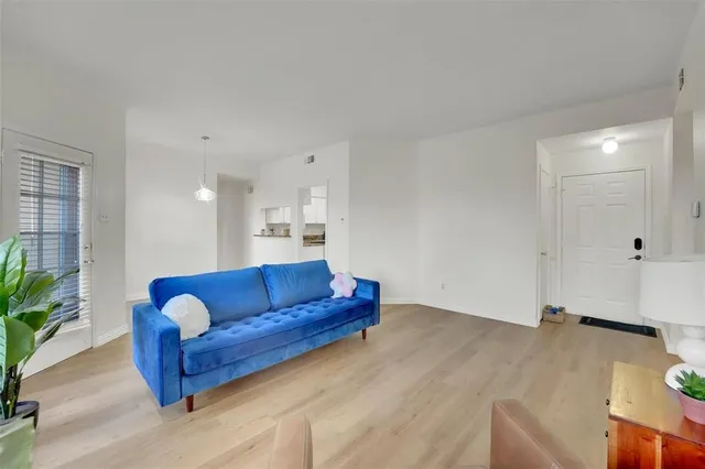a view of kitchen with furniture and wooden floor