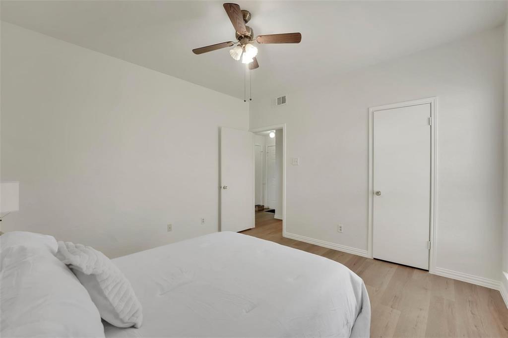 1700 Amelia Court, Unit 312 Plano, TX 75075 - Photo 17 of 30 a bedroom with a bed and a ceiling fan