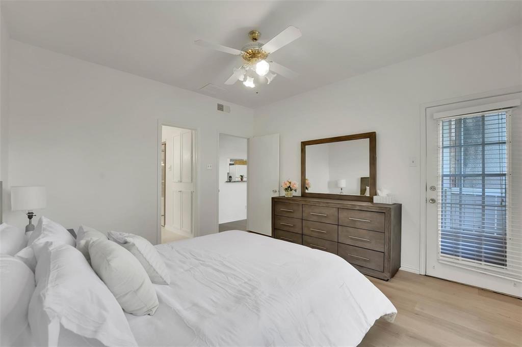 1700 Amelia Court, Unit 312 Plano, TX 75075 - Photo 19 of 30 a bedroom with a bed and a dresser