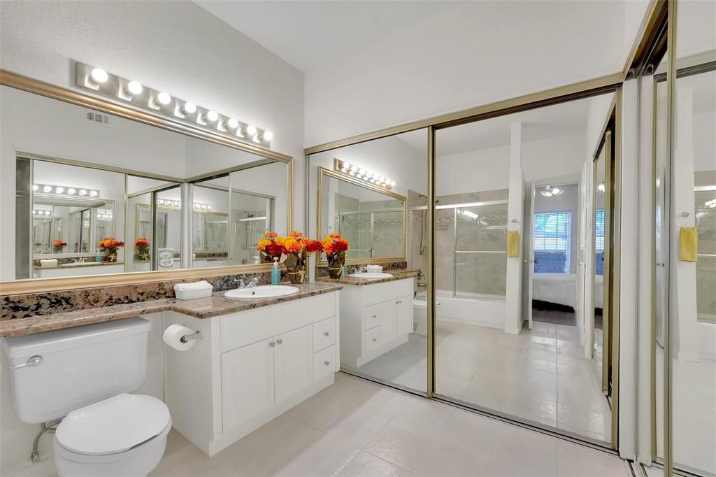 1700 Amelia Court, Unit 312 Plano, TX 75075 - Photo 23 of 30 a bathroom with a sink a toilet and a mirror