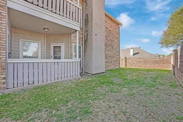 a view of pool with outdoor seating and house in the background