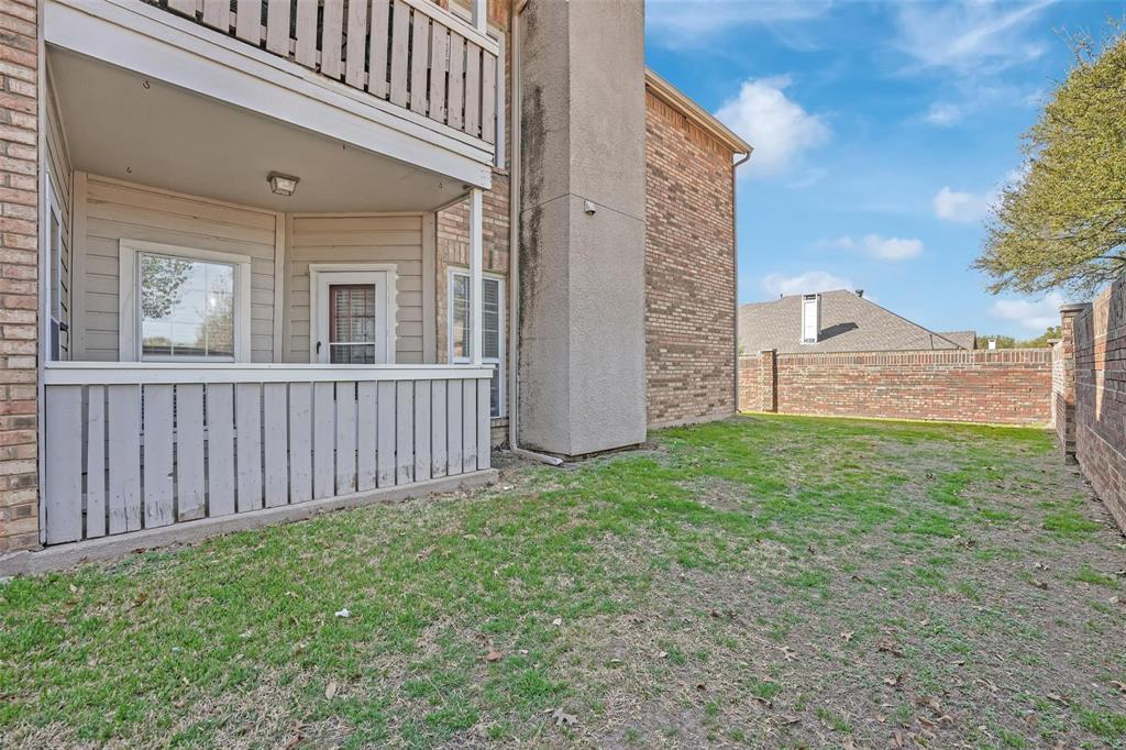 1700 Amelia Court, Unit 312 Plano, TX 75075 - Photo 28 of 30 a view of a house with a small yard and wooden fence