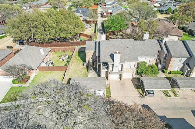 an aerial view of a house with a yard basket ball court and outdoor seating