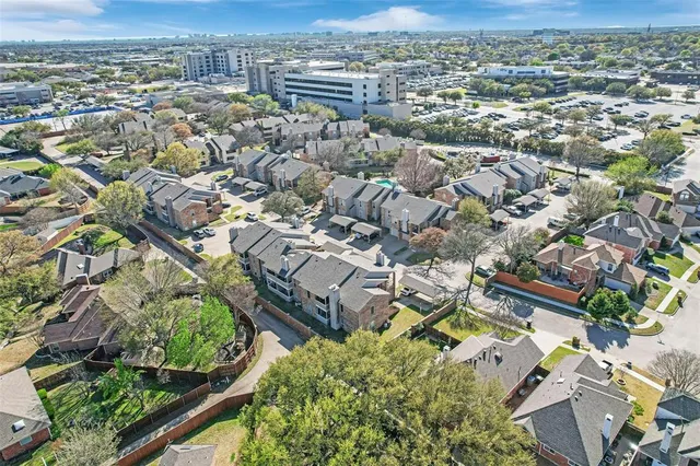 an aerial view of residential houses with outdoor space