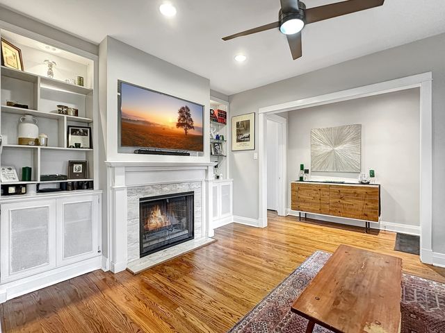 a living room with a fireplace and a flat screen tv