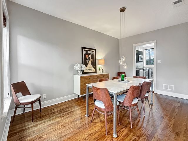 a view of a dining room with furniture and wooden floor