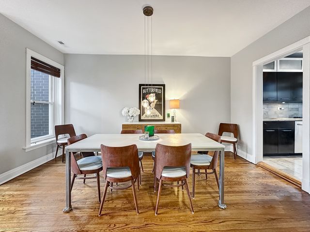 a view of a dining room with furniture and wooden floor