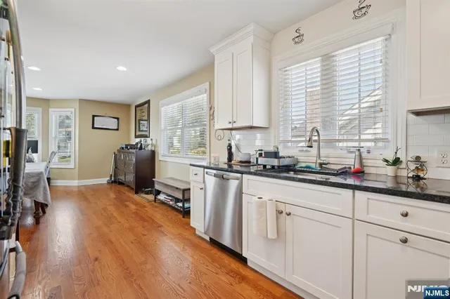 a kitchen with sink cabinets and wooden floor