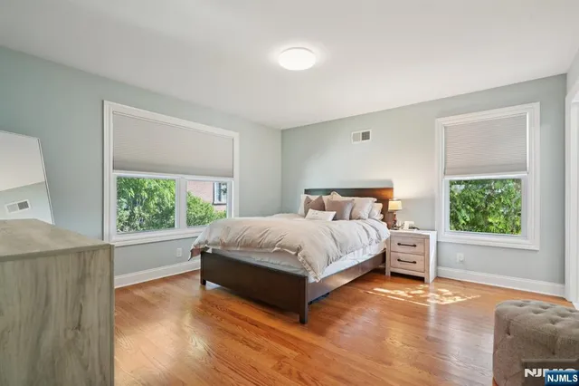 a bedroom with a bed and a large window